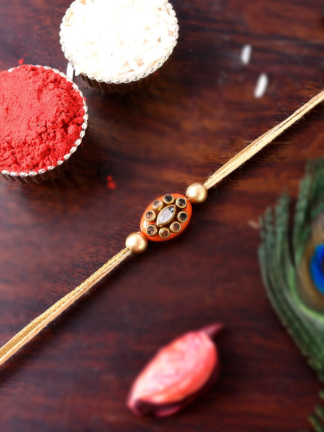 

Shoshaa Gold-Toned Orange Kundan Stone Single Bhai Rakhi