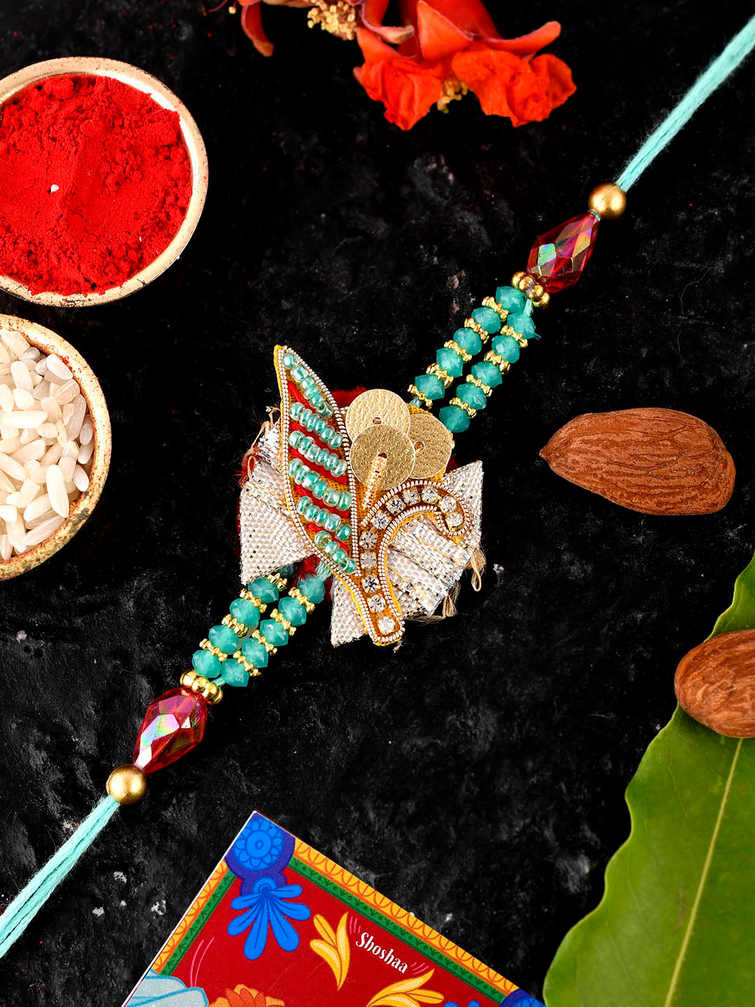 

Shoshaa Men Gold-Toned Turquoise Blue Stone-Studded Single Bhai Rakhi With Roli Chawal