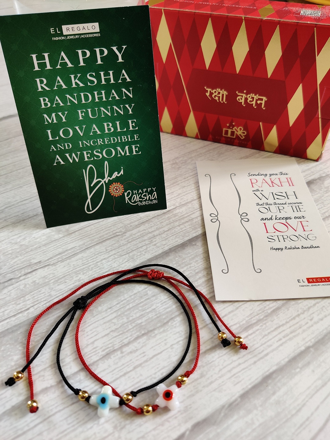 

EL REGALO Bhaiya Bhabhi 2 Pack Evil Eye Rakhi With Roli Chawal & Greeting Card, Red