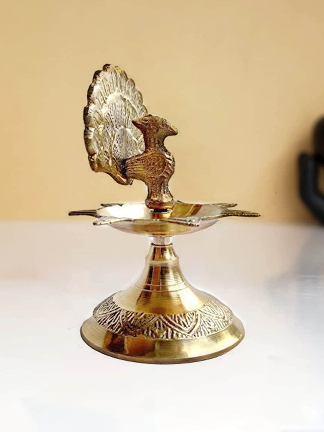 

Craftvatika Gold Toned Brass Peacock Design Diya