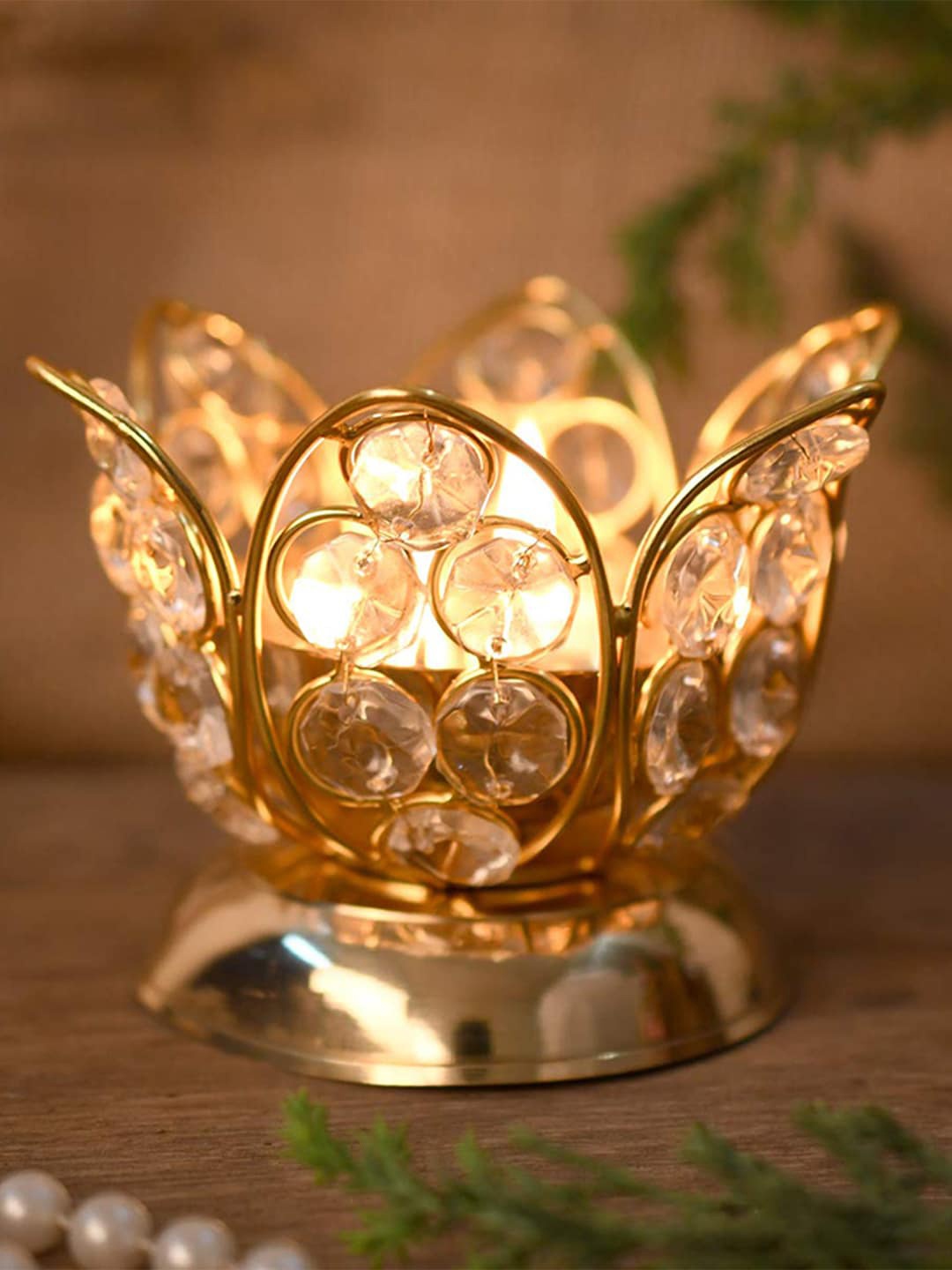 

Craftvatika Gold Toned Crystal Lotus Shaped Diya