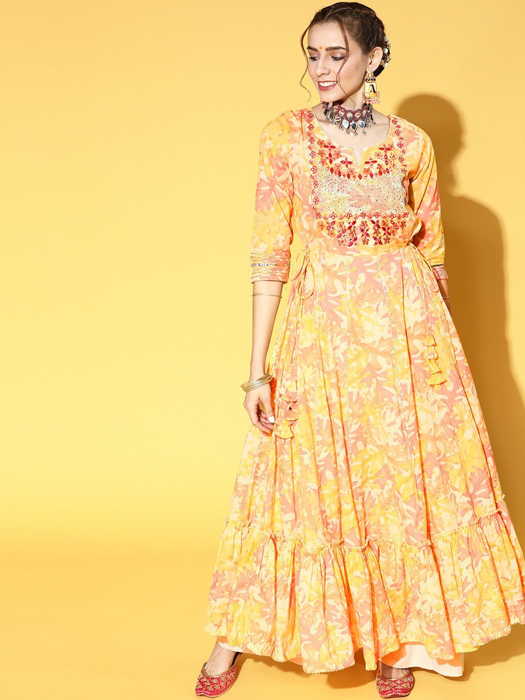 

Ishin Women Yellow Floral Sequinned Mirror Work Yoke Design Tiering Anarkali Kurta