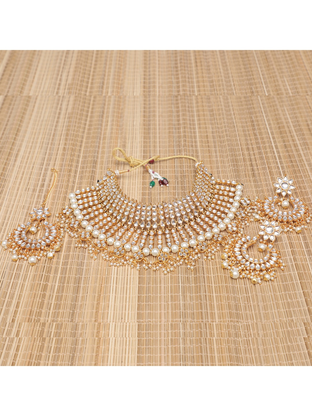 

Swarajshop Gold-Plated White Kundan Studded & Beaded Jewellery Set