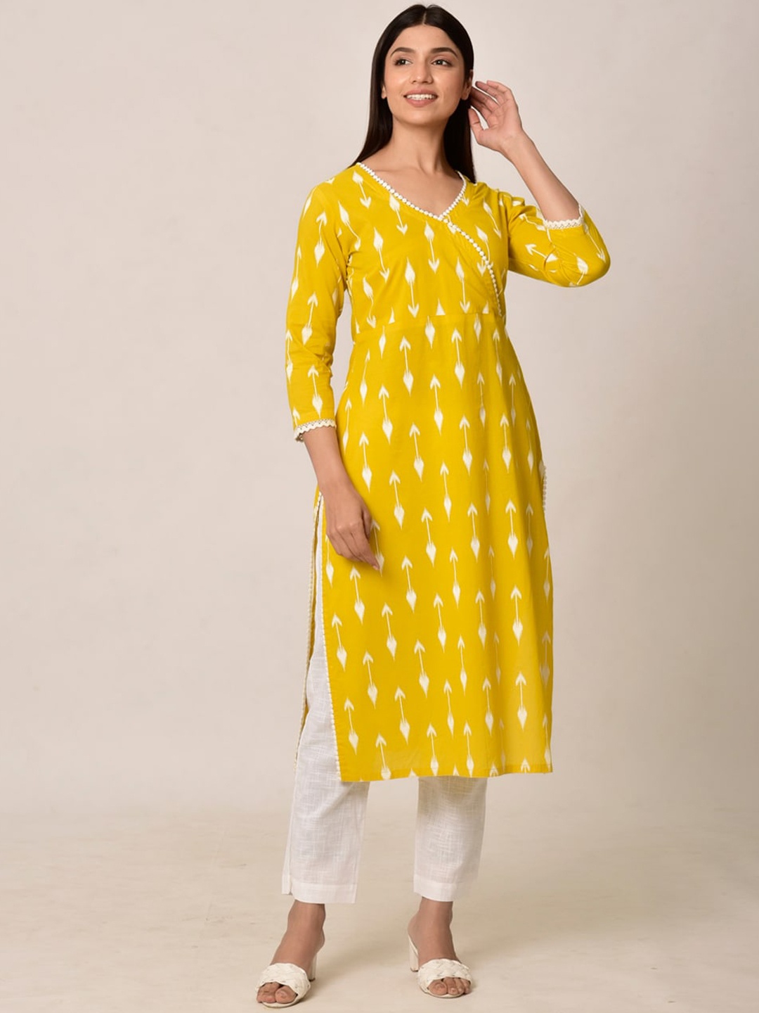 

Ikk Kudi by Seerat Women Yellow Printed Angrakha Pure Cotton Kurti with Trousers