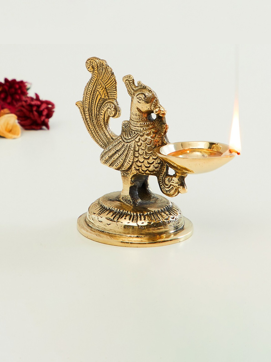 

Home Centre Gold-Toned Textured Peacock Metal Pooja Diya
