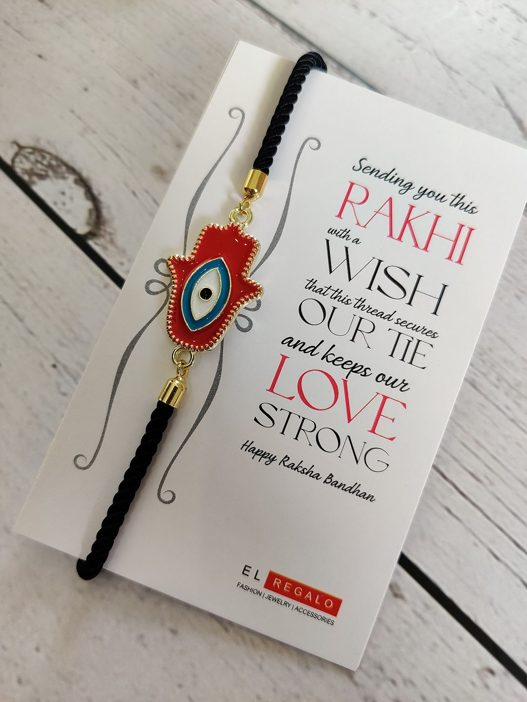 

EL REGALO Evil Eye Rakhi Combo for Bhaiya With Roli Chawal Shagun and Greeting Card, Red