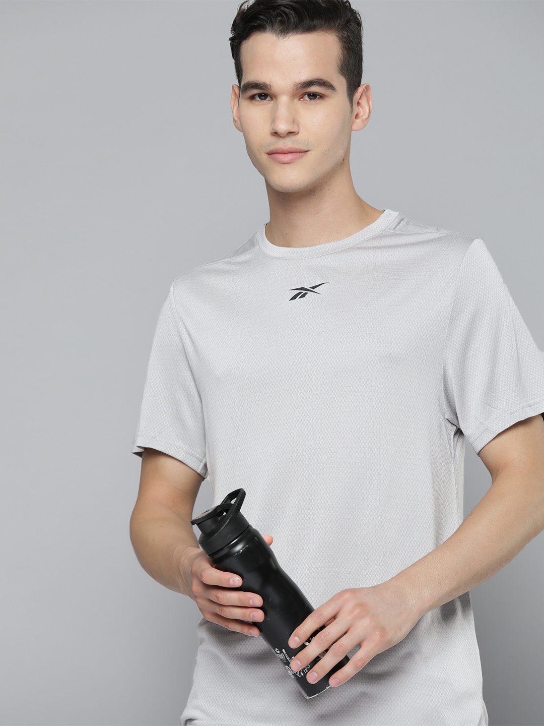 

Reebok Men Grey Melange Self-Design Training T-shirt