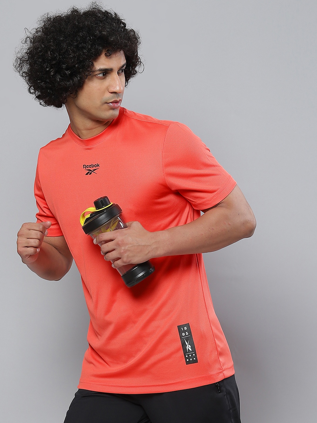 

Reebok Men Coral Orange Printed Slim Fit T-shirt