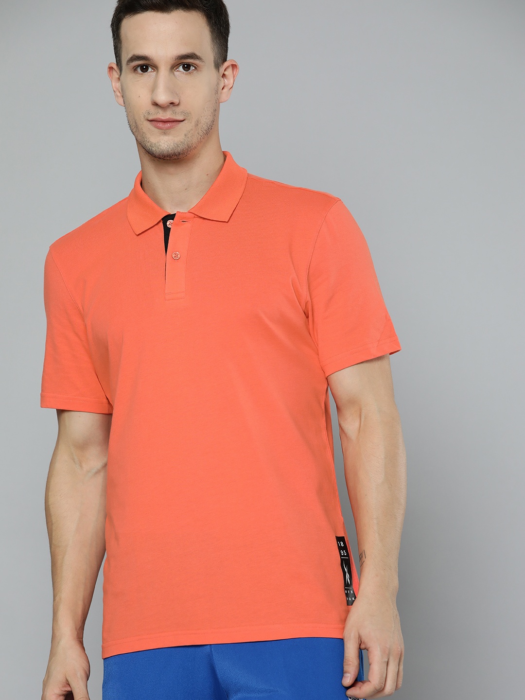 

Reebok Men Orange Solid Polo Collar Pure Cotton T-shirt