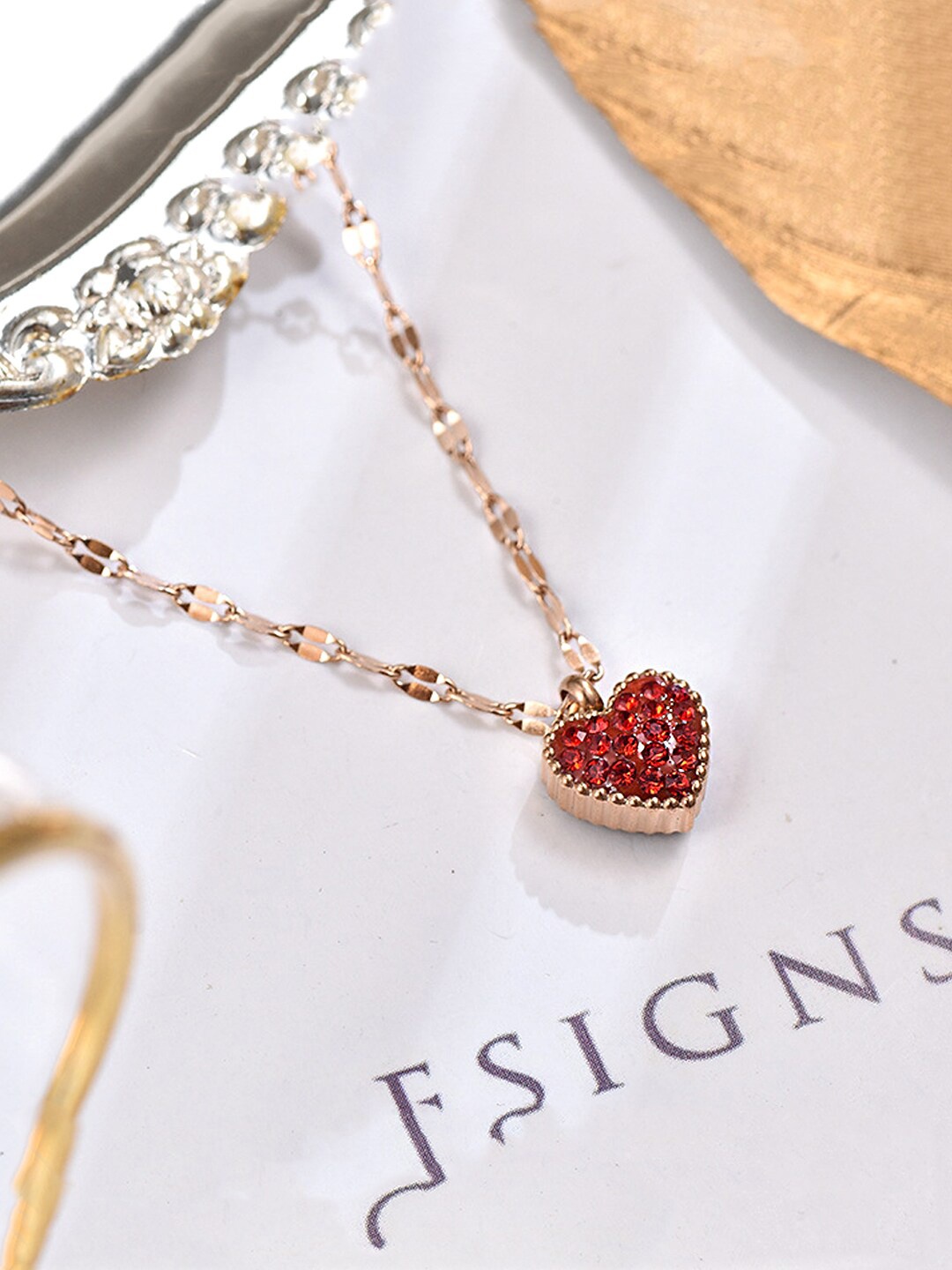 

Yellow Chimes Rose Gold-Plated Red Stone-Studded Heart Charm Pendant With Chain