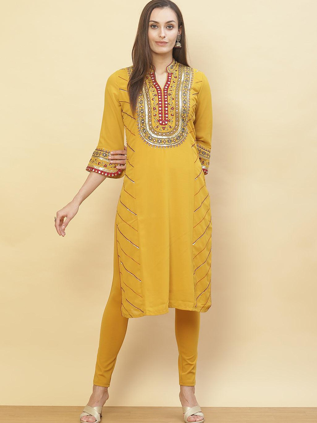 

Lakshita Women Yellow Ethnic Motifs Embroidered Flared Sleeves Thread Work Georgette Kurta