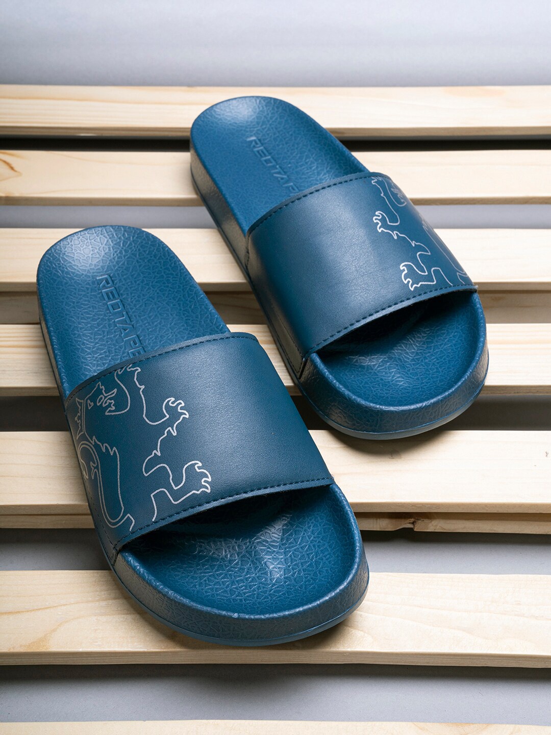 

Red Tape Men Blue & White Printed Rubber Sliders