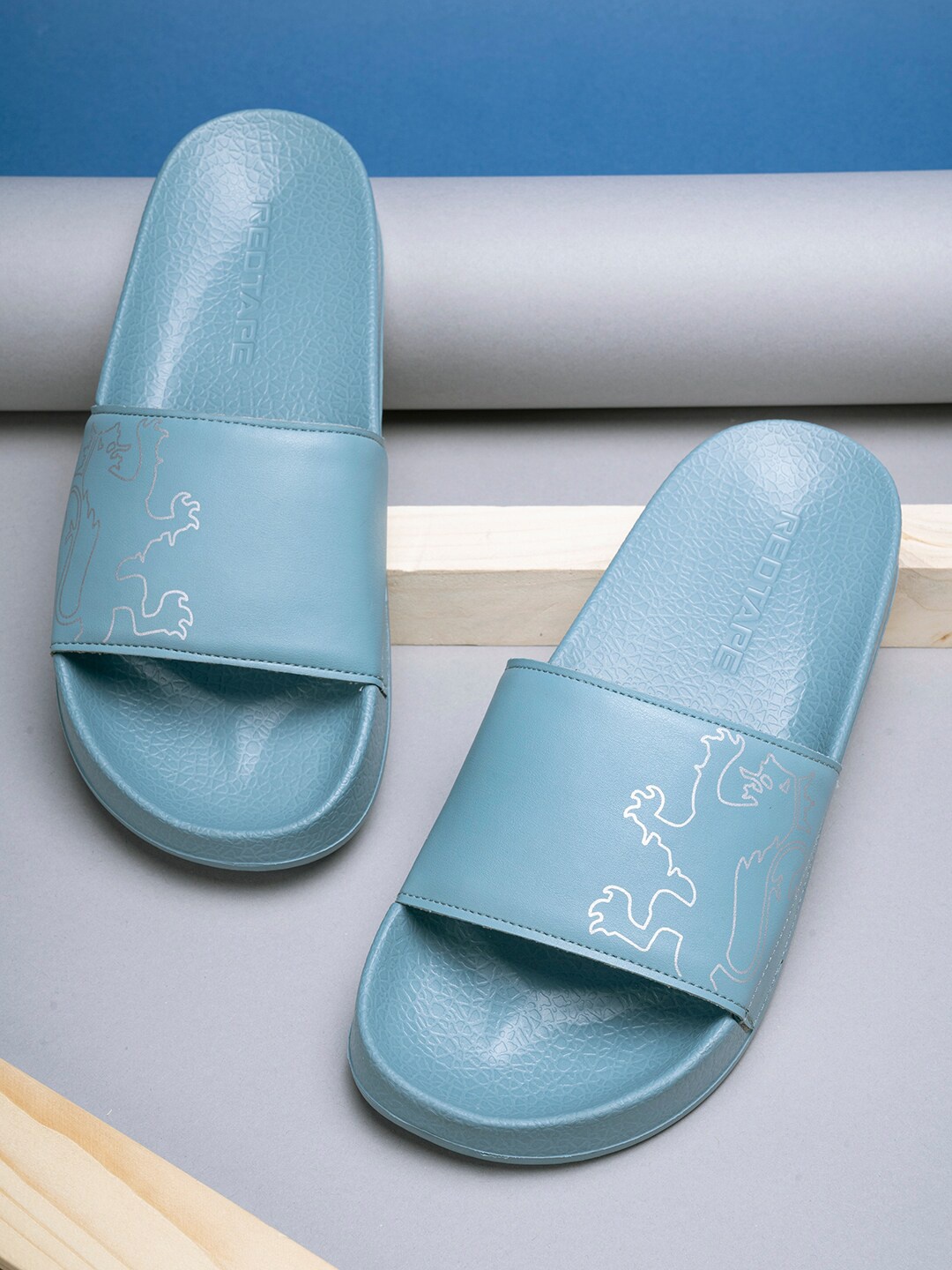 

Red Tape Men Blue & White Printed Rubber Sliders