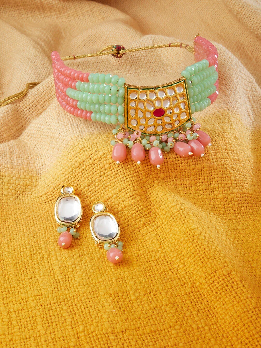 

Zaveri Pearls Gold-Plated Green & Pink Stone-Studded & Beaded Jewellery Set