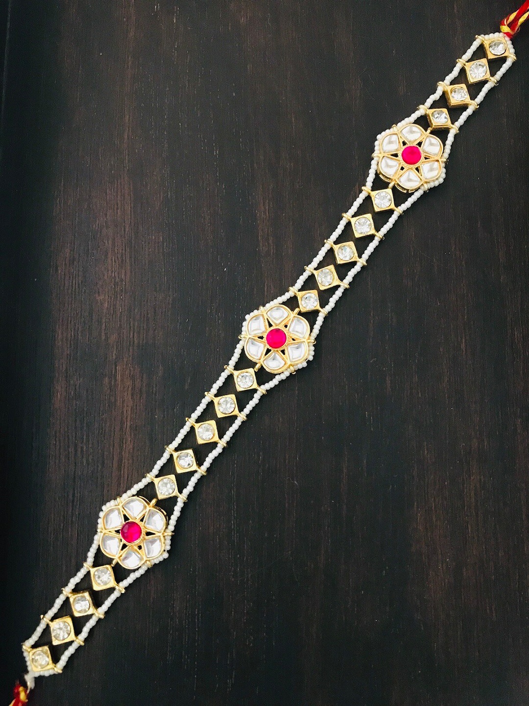 

The Opal Factory Gold Plated & Red Studded Floral Mathapatti