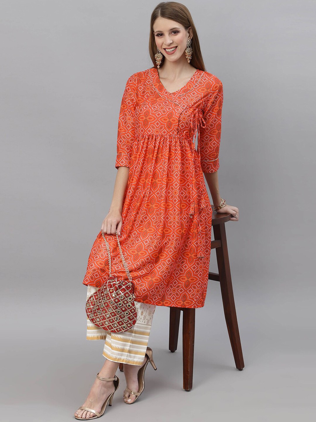 

KALINI Women Orange Striped Pleated Cotton Blend Kurta with Trousers