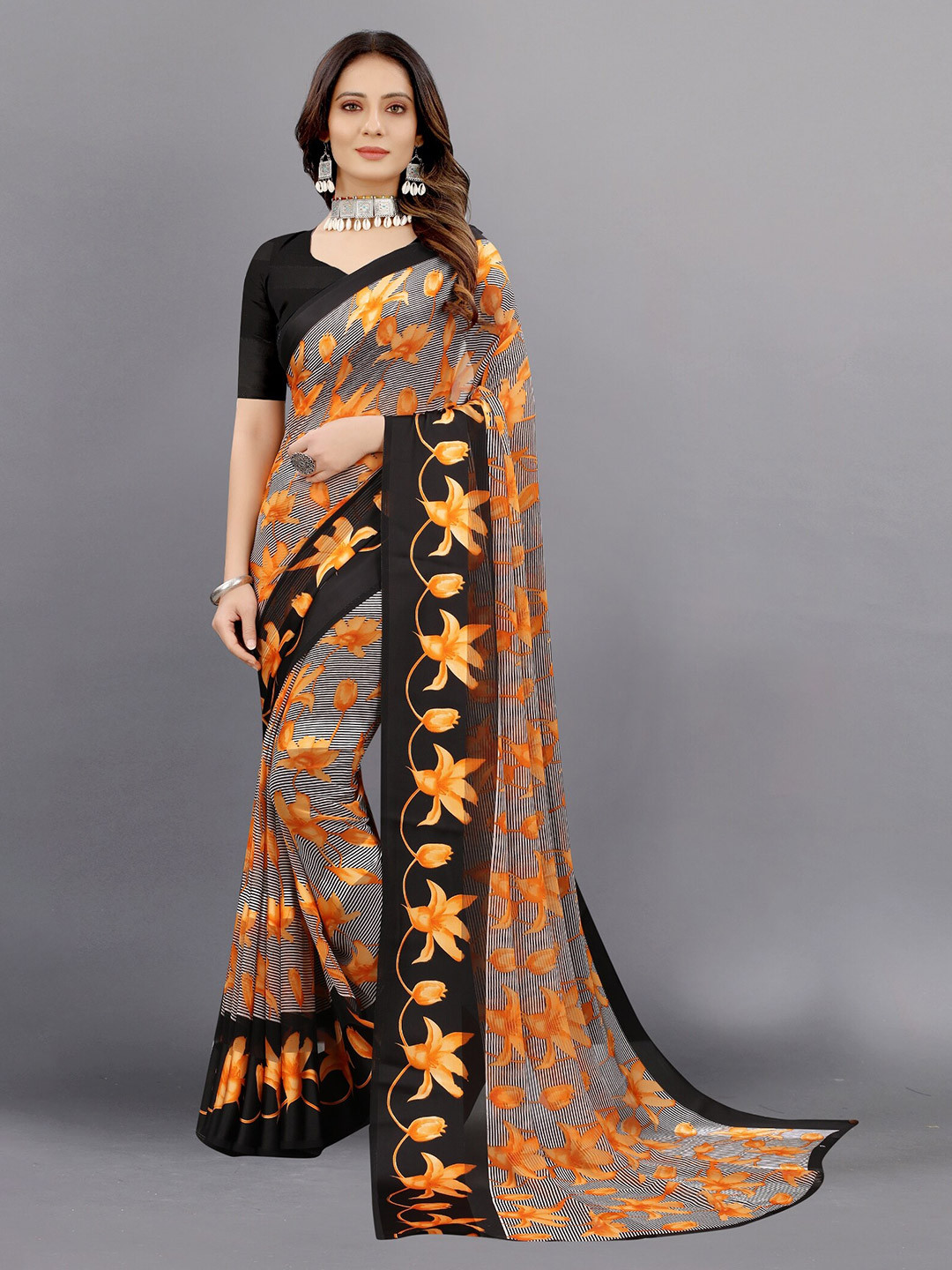 

APNISHA Orange & Black Floral Zari Pure Georgette Saree
