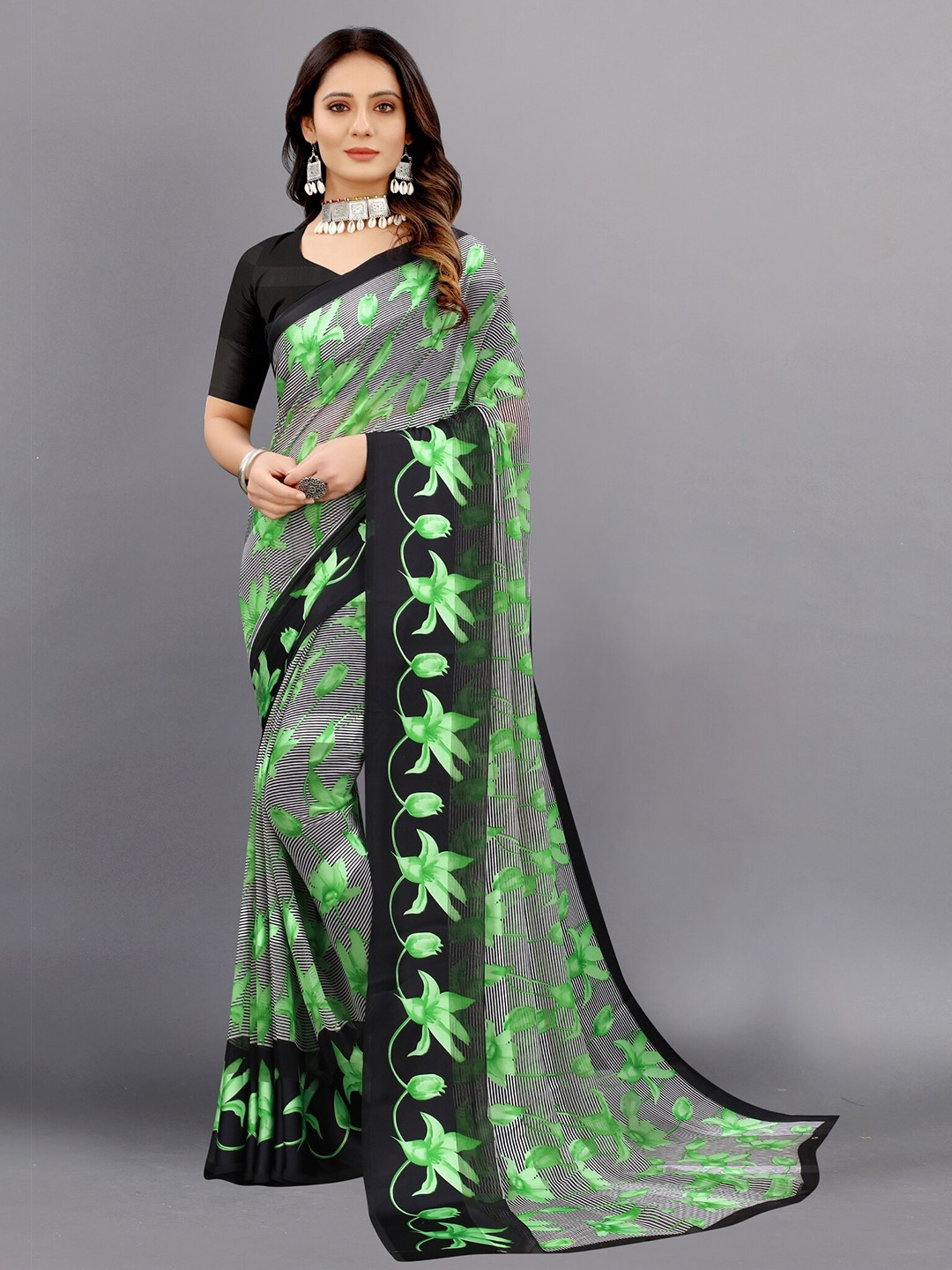 

APNISHA Teal & Black Floral Zari Pure Georgette Saree