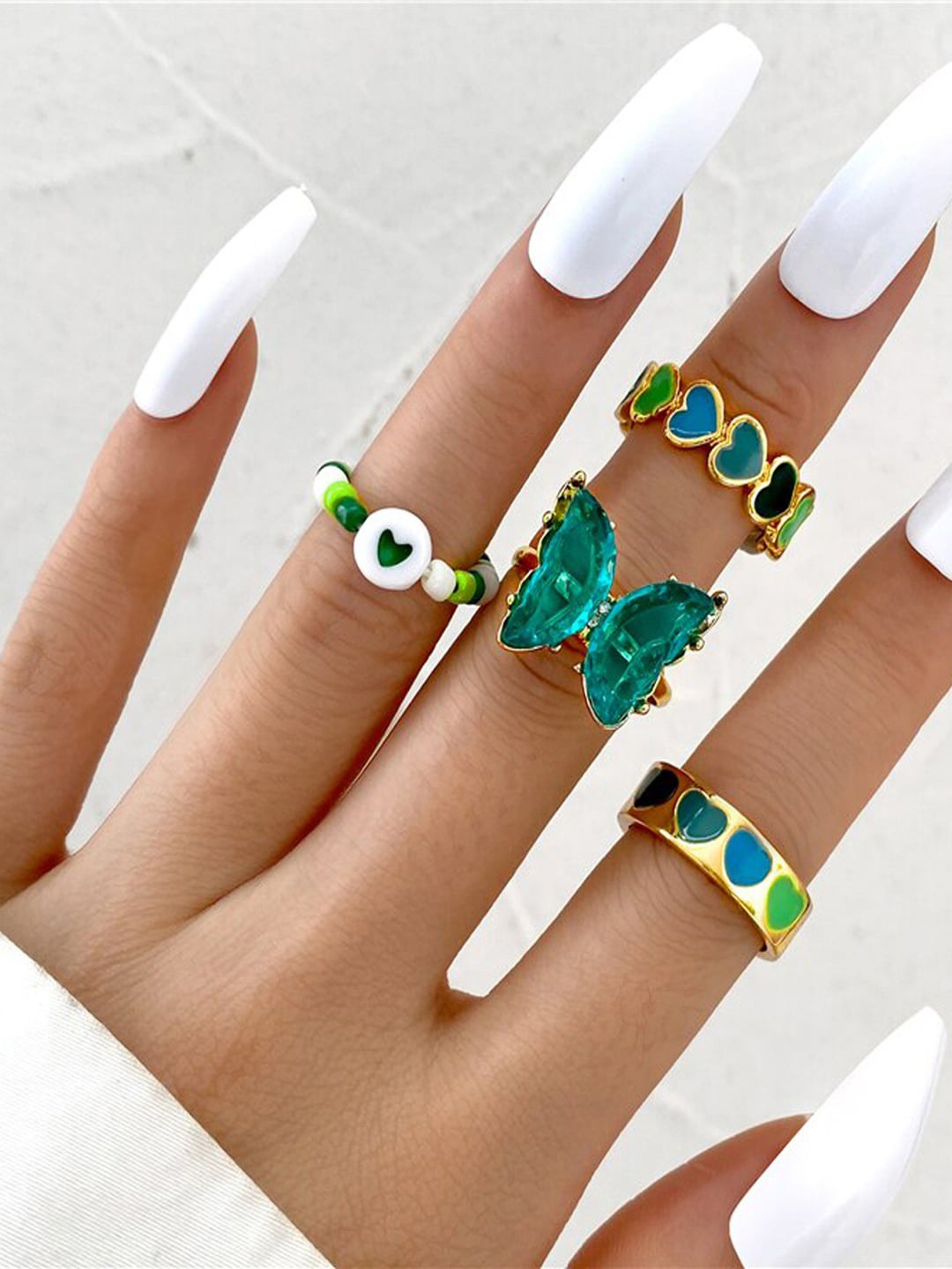 

Shining Diva Fashion Set Of 4 Gold-Plated Green Crystal-Studded Finger Ring