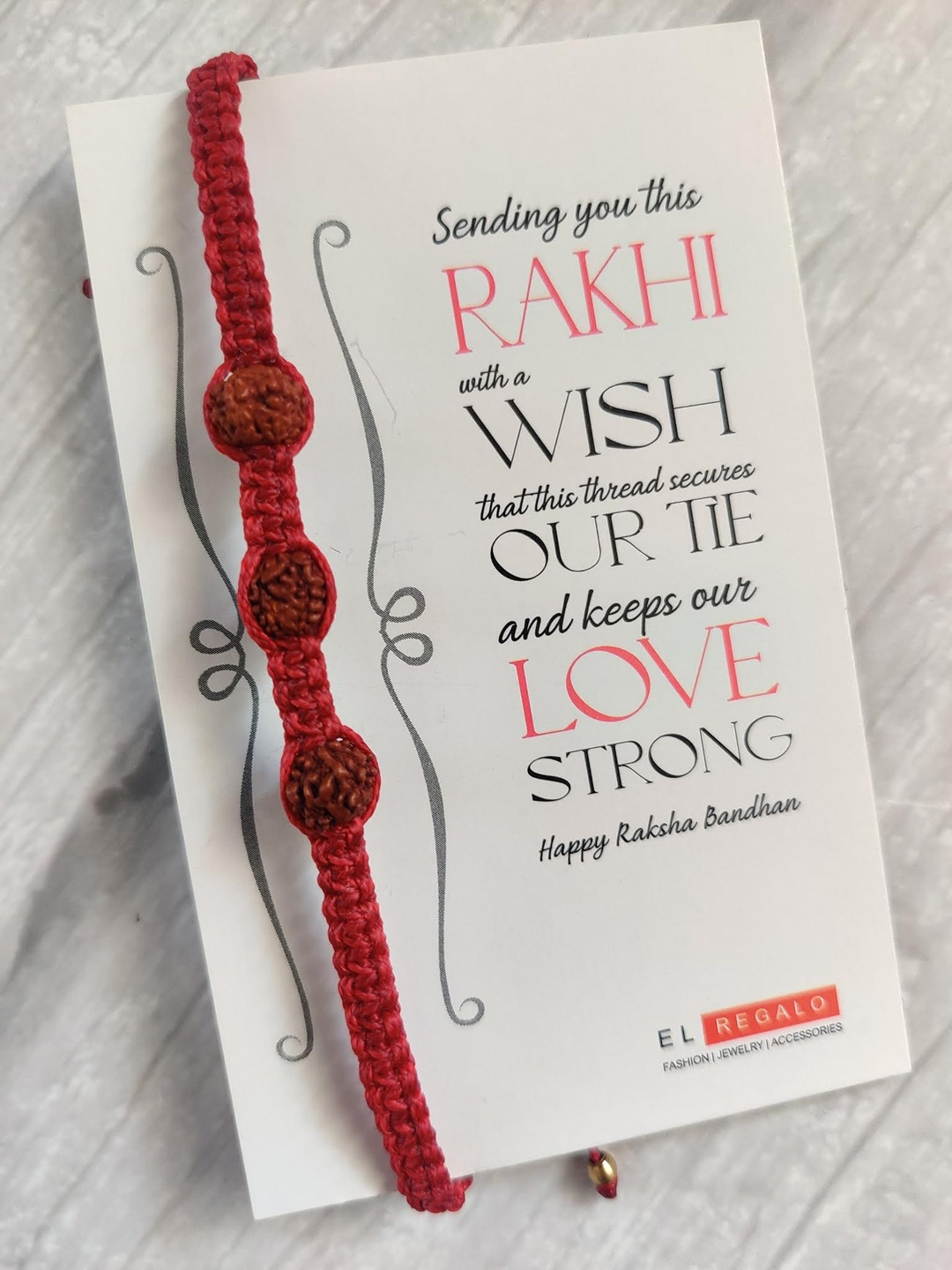 

EL REGALO Rudraksha Rakhi Combo for Bhai With Roli Chawal Shagun and Greeting Card, Red