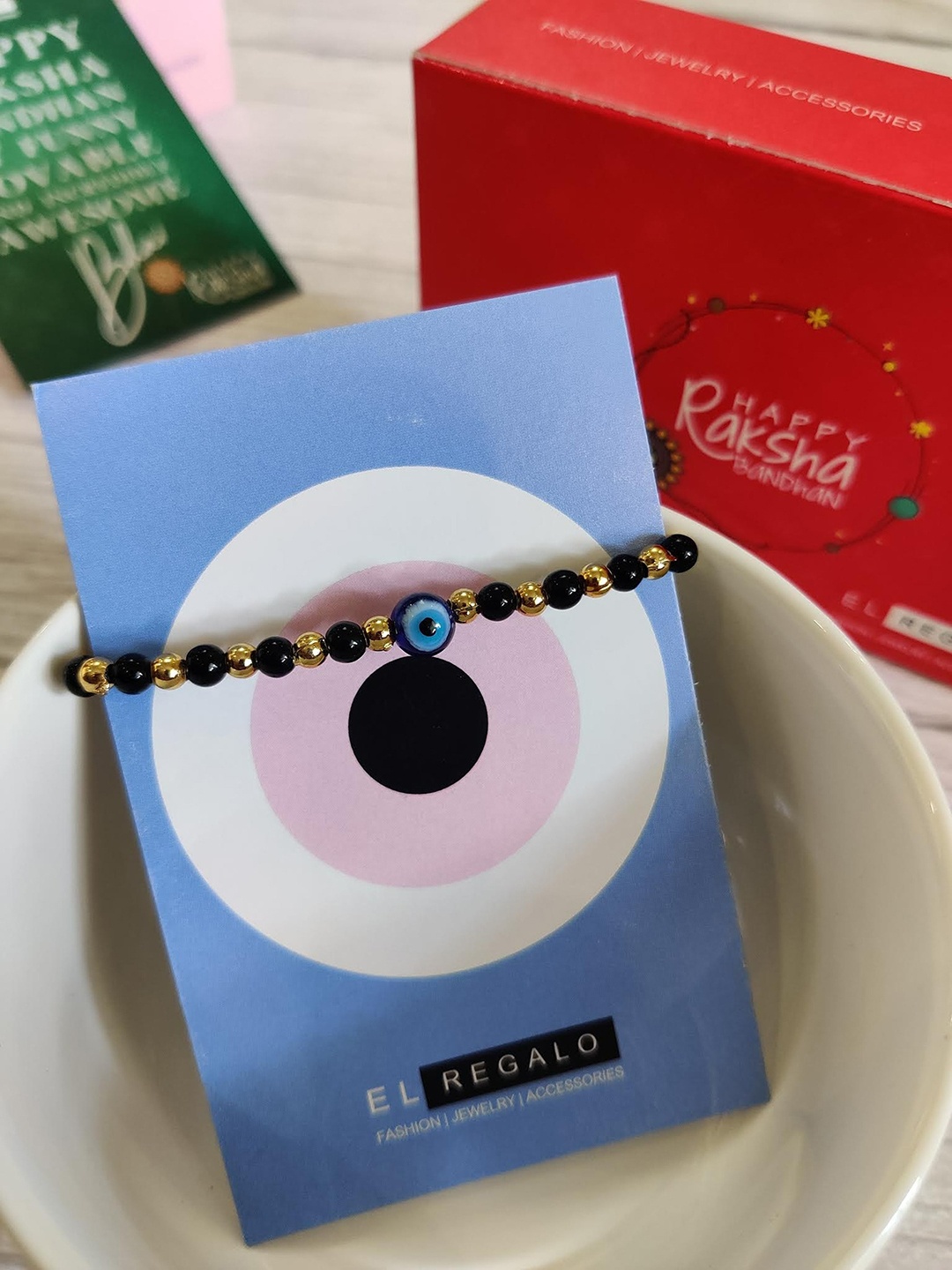 

EL REGALO Bracelet Rakhi Combo for Baby With Roli Chawal Shagun and Greeting Card, Black