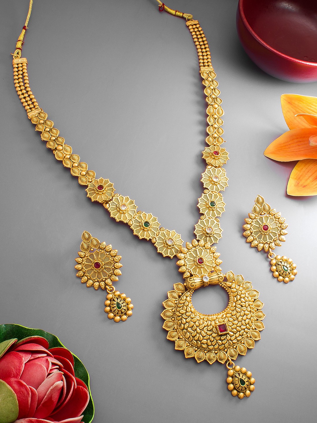 

aadita Gold-Plated Red & Green Stone Studded & Beaded Jewellery Set