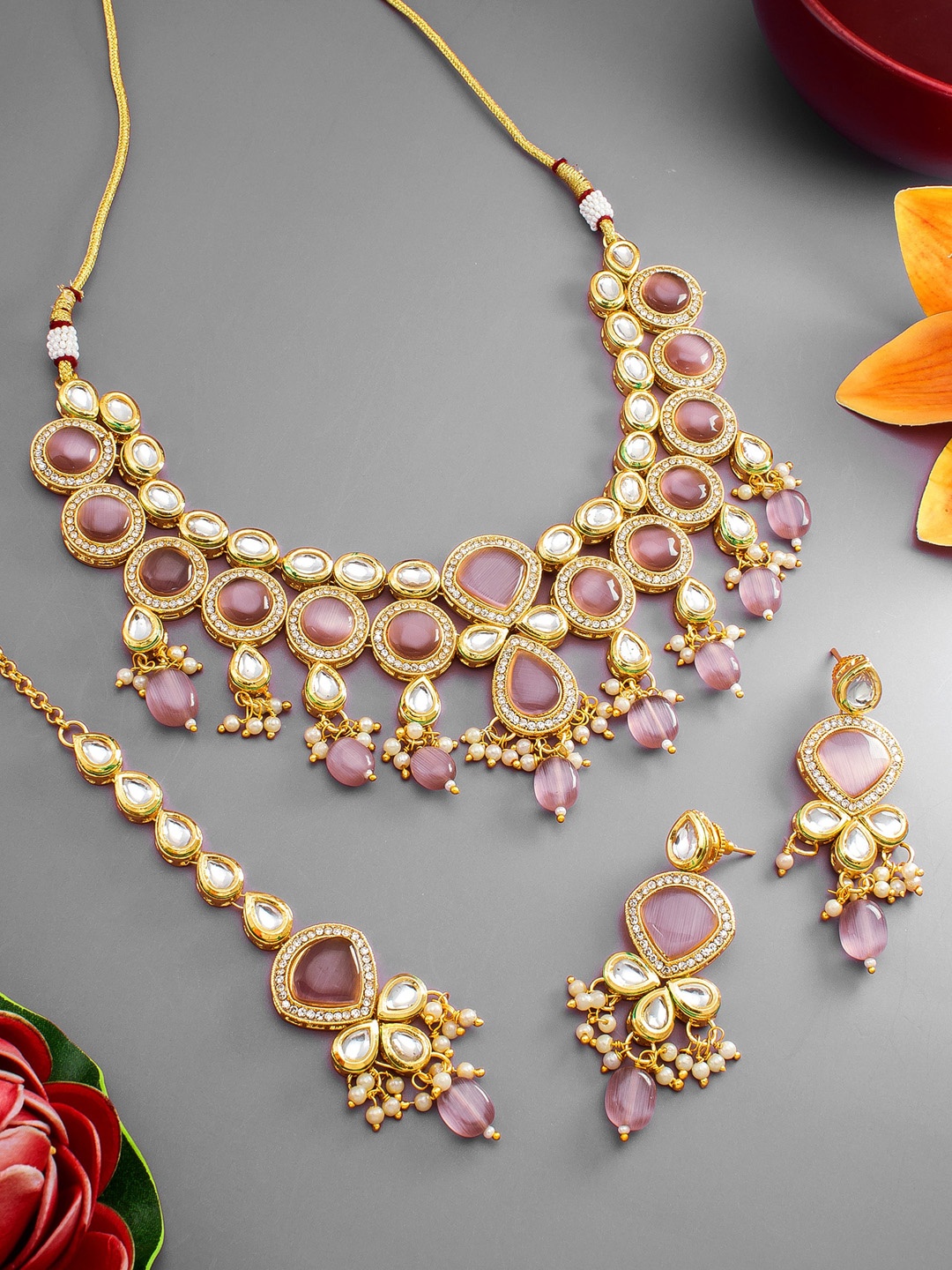 

aadita Gold Plated White & Pink Stone Studded Jewellery Set