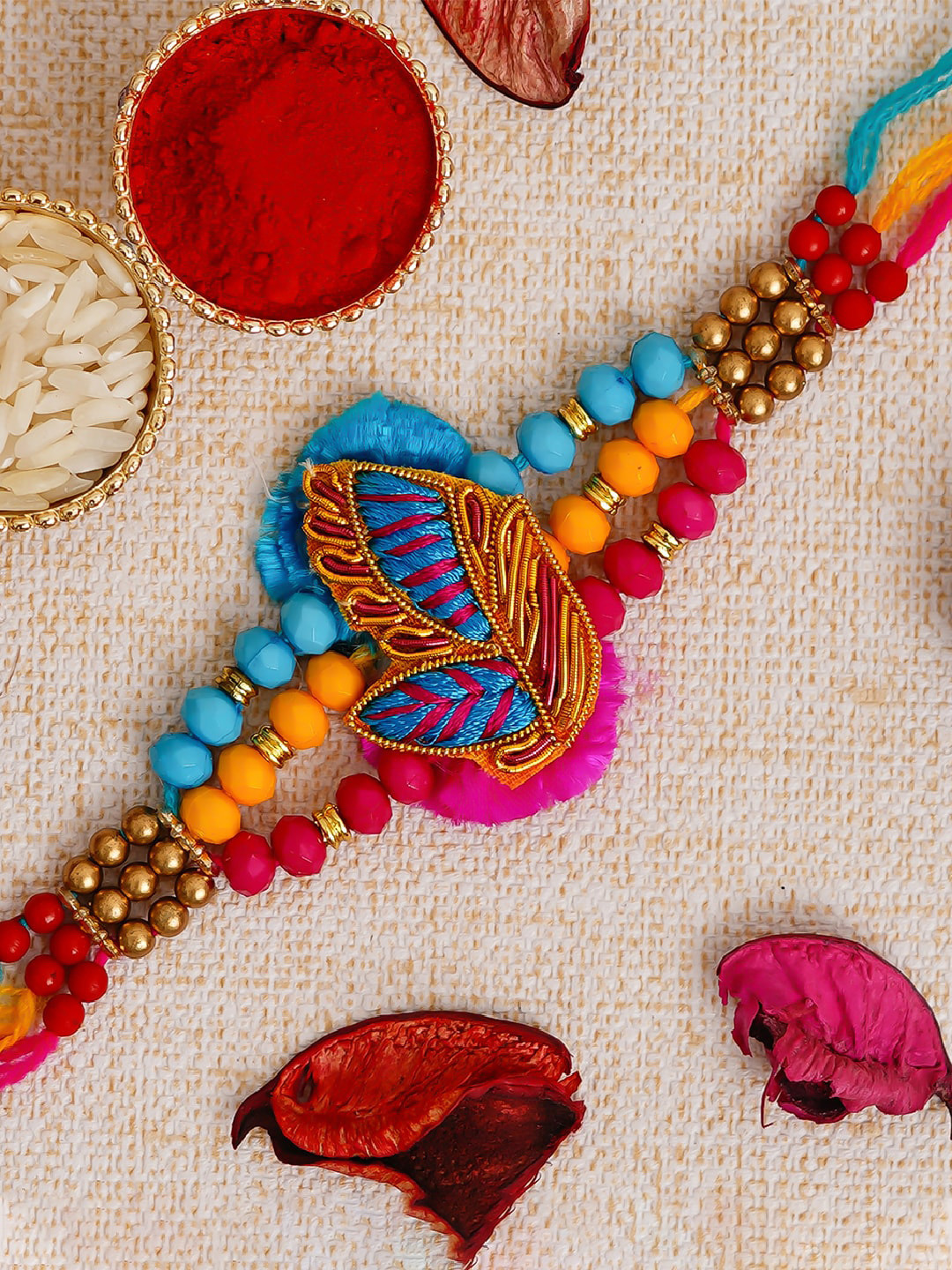 

eCraftIndia Pink & Blue Fancy Thread Rakhi with Roli Chawal
