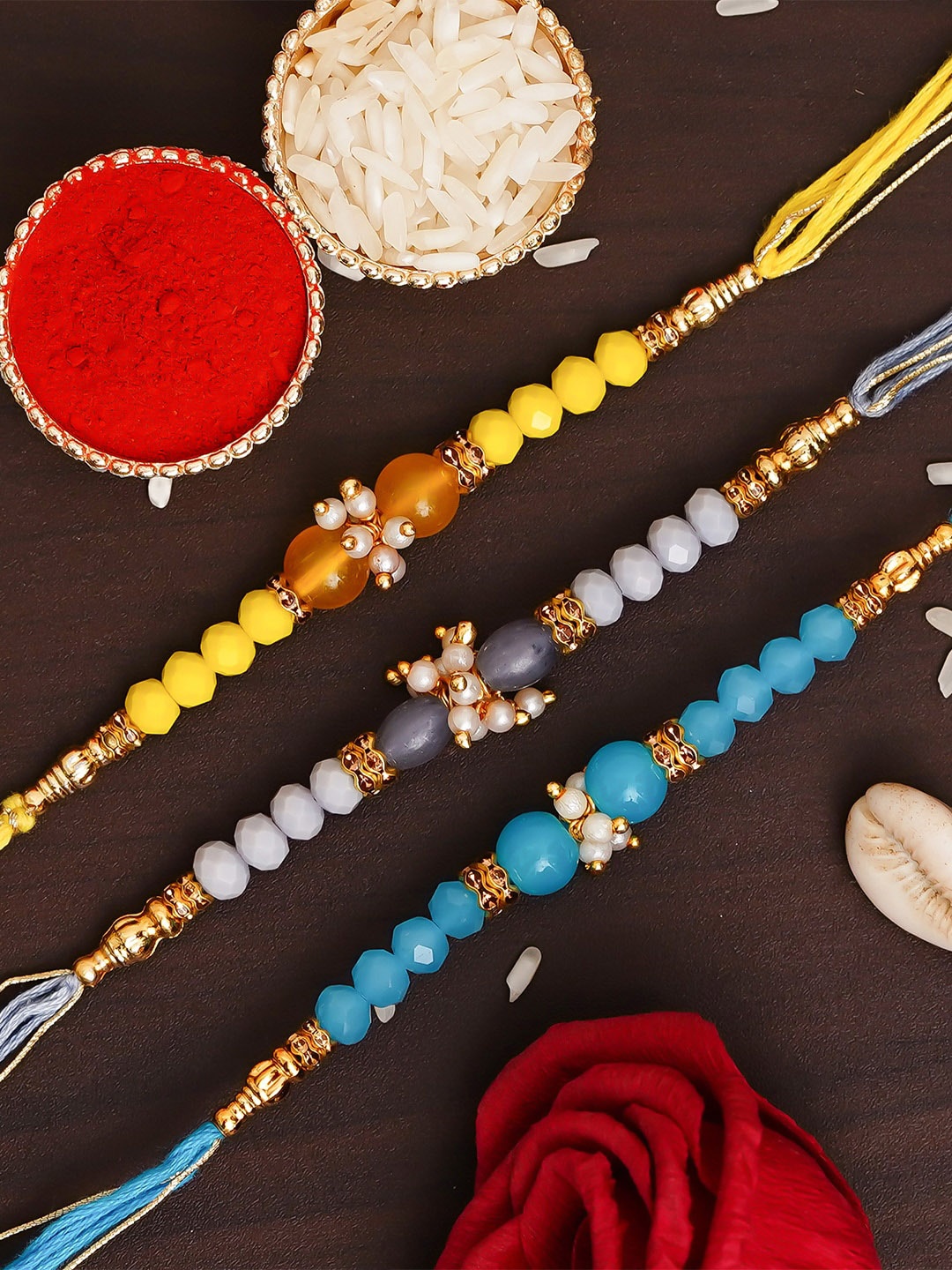 

eCraftIndia Pack of 3 Designer Pearl Rakhis & Roli Chawal, Yellow