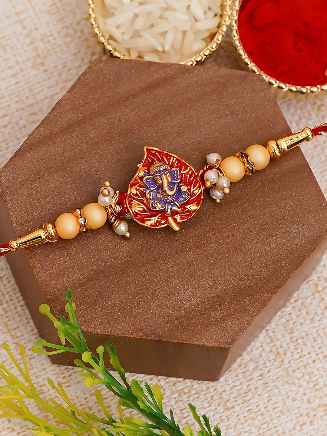 

eCraftIndia Golden & Red Ganesha On Leaf Rakhi and Roli Chawal Pack, Gold
