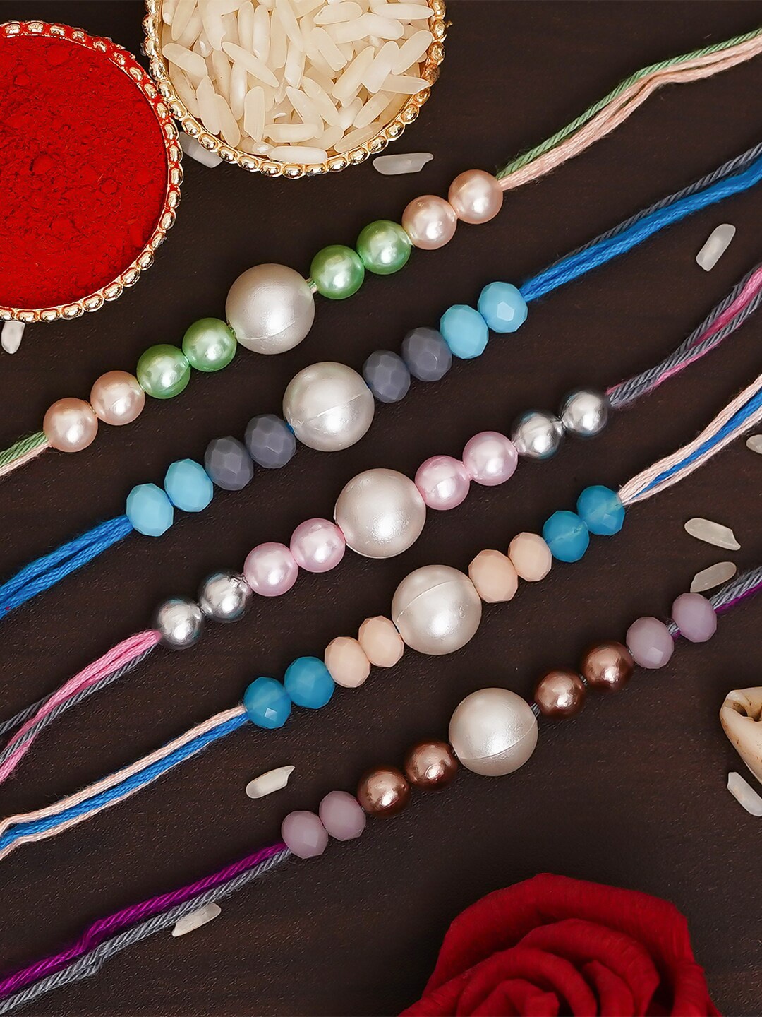 

eCraftIndia Pack Of 5 Multicolor Pearl Rakhis & Roli Chawal, Multi