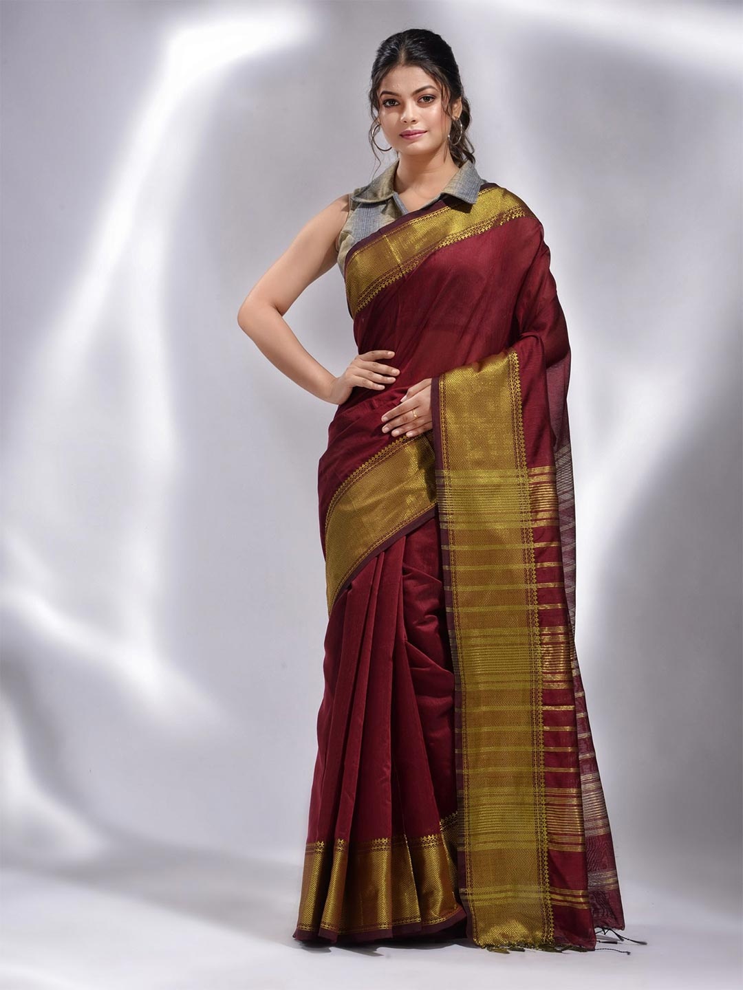 

Charukriti Maroon & Gold-Toned Zari Saree