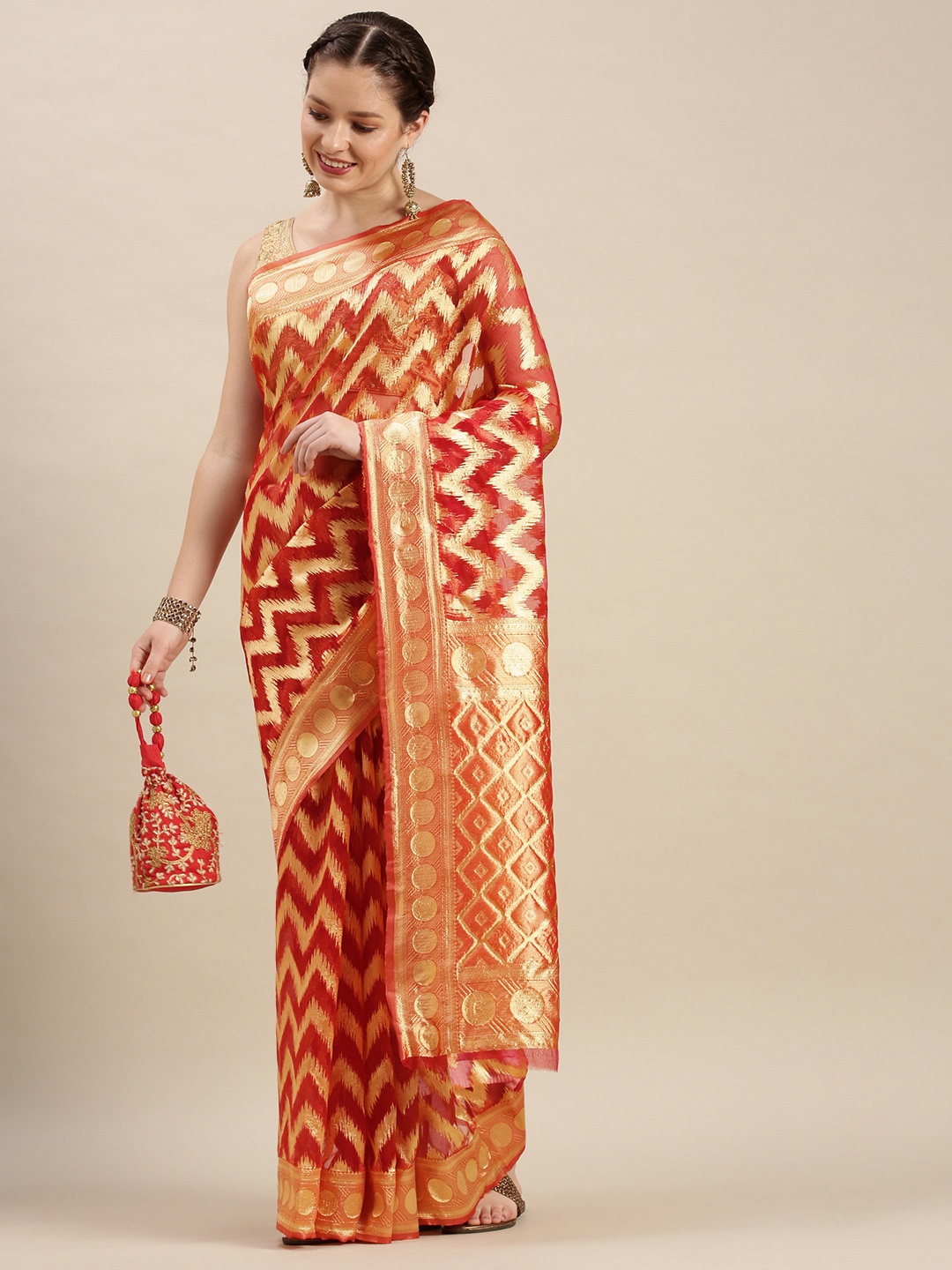 

Rivana Rust Red & Gold Chevron Zari Organza Celebrity Banarasi Saree