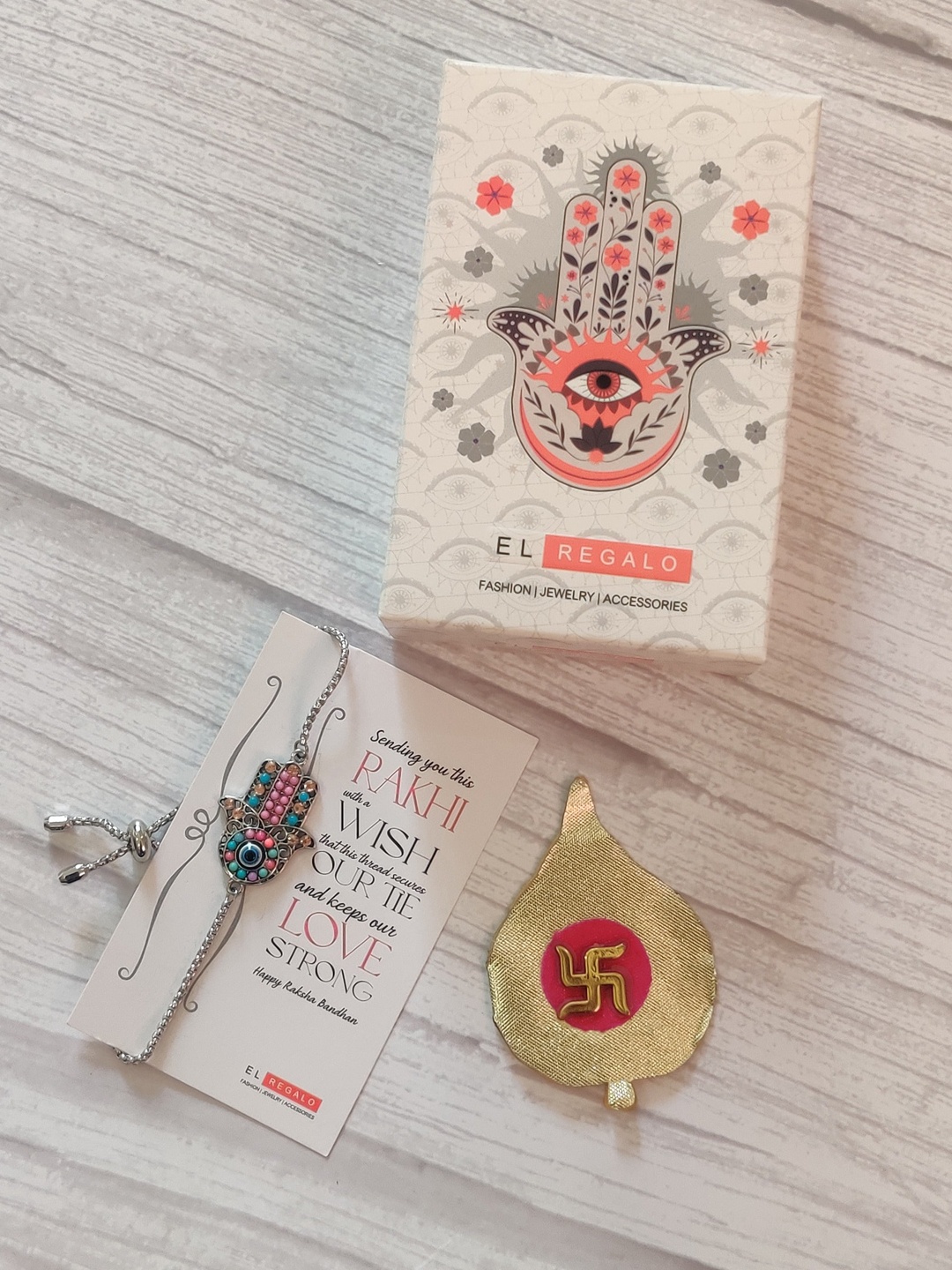 

EL REGALO Pink & Turquoise Blue Rakhi with Roli Chawal & Greetings Card