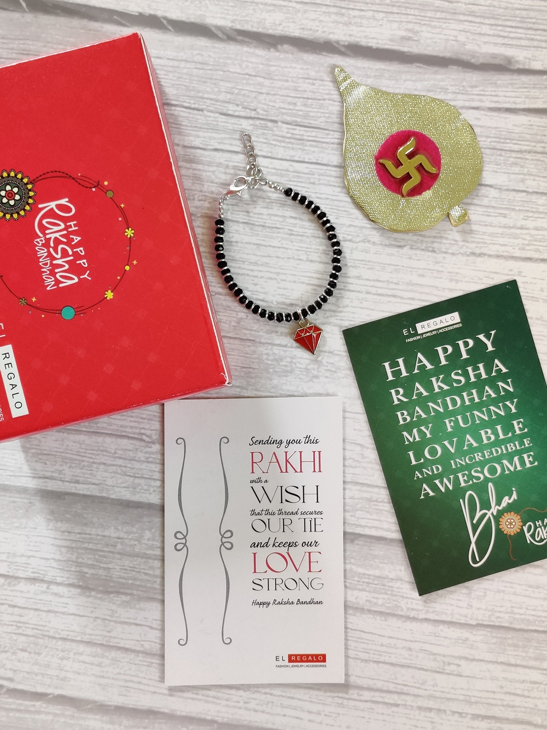 

EL REGALO Kids Red Nazaria Rakhi Combo with Greeting Card & Roli Chawal Shagun