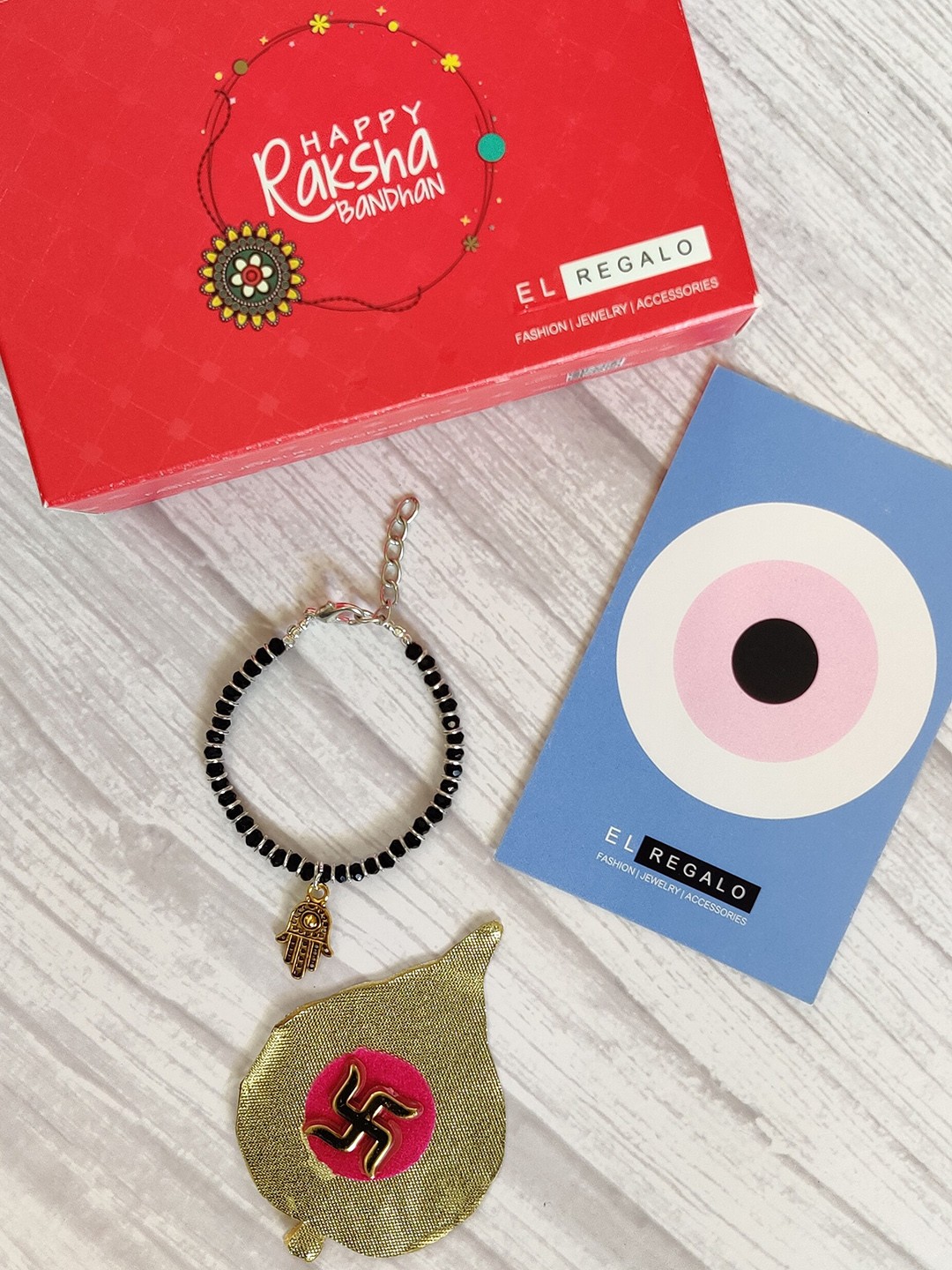 

EL REGALO Kids Golden Nazaria Rakhi Combo with Greeting Card & Roli Chawal Shagun, Gold
