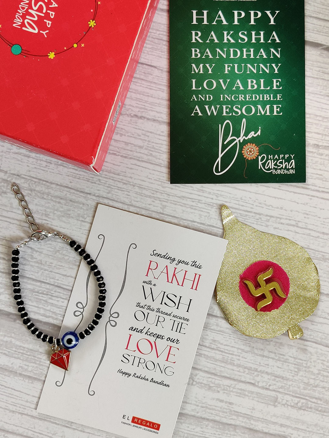 

EL REGALO Kids Red Nazaria Rakhi Combo with Greeting Card & Roli Chawal Shagun