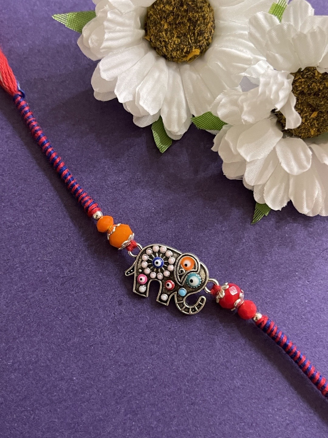 

Digital Dress Room Men Silver-Toned & Red Beaded Rakhi