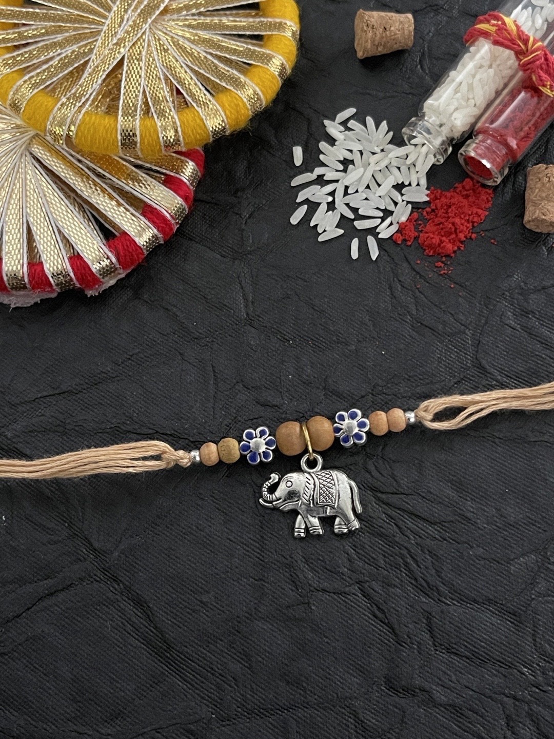 

Digital Dress Room Men Cream Colored Elephant Charm Thread Rakhi