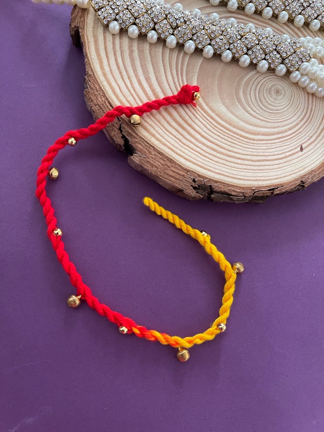 

Digital Dress Room Men Red & Yellow Ghungroo Beaded Rakhi