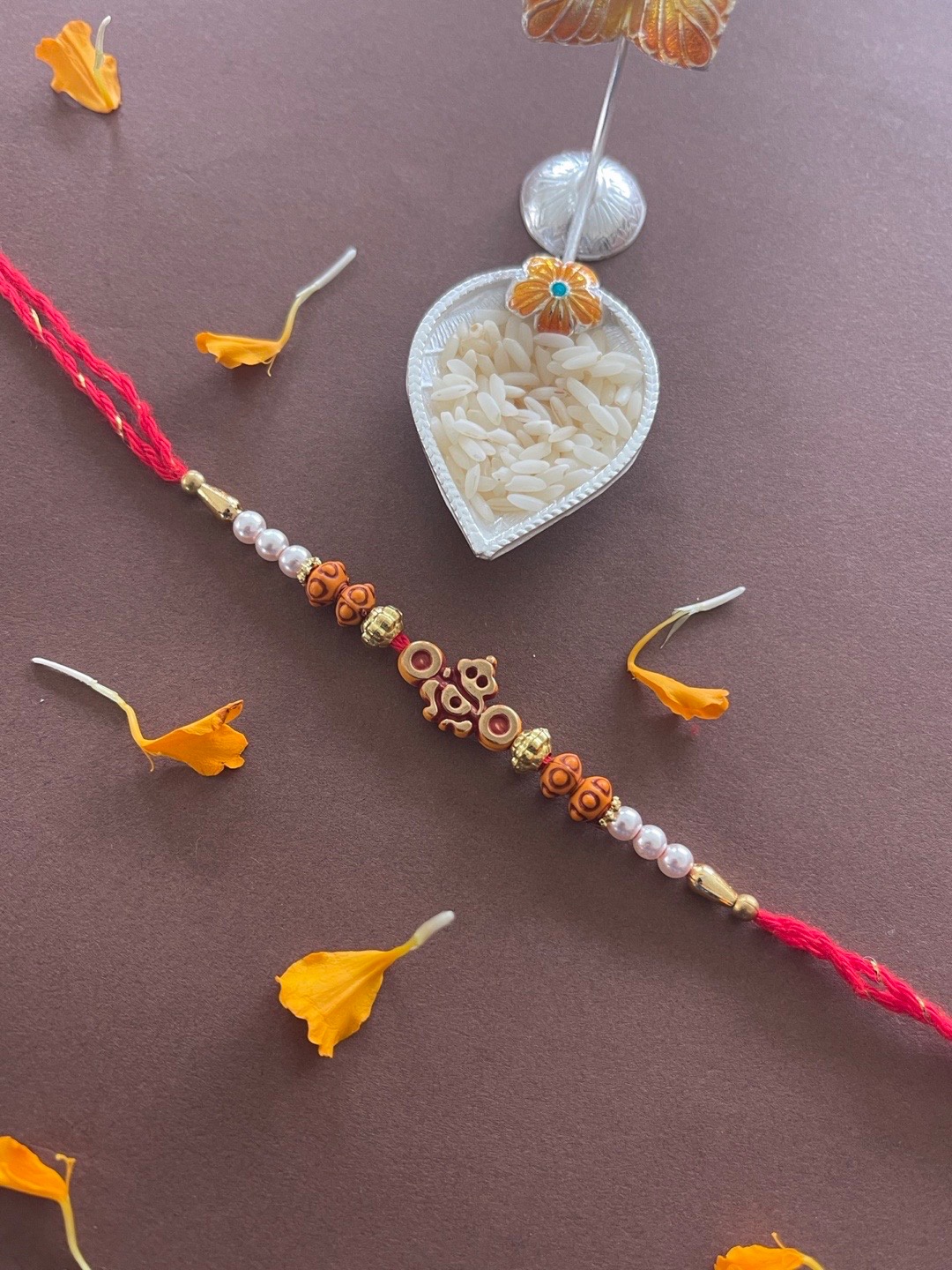 

Digital Dress Room Men Red & White Beaded & Lord Ganesh-Charm Rakhi With Roli