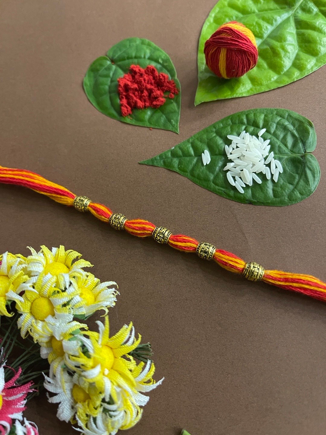 

Digital Dress Room Men Red & Yellow Threaded Gold-Toned Beaded Rakhi