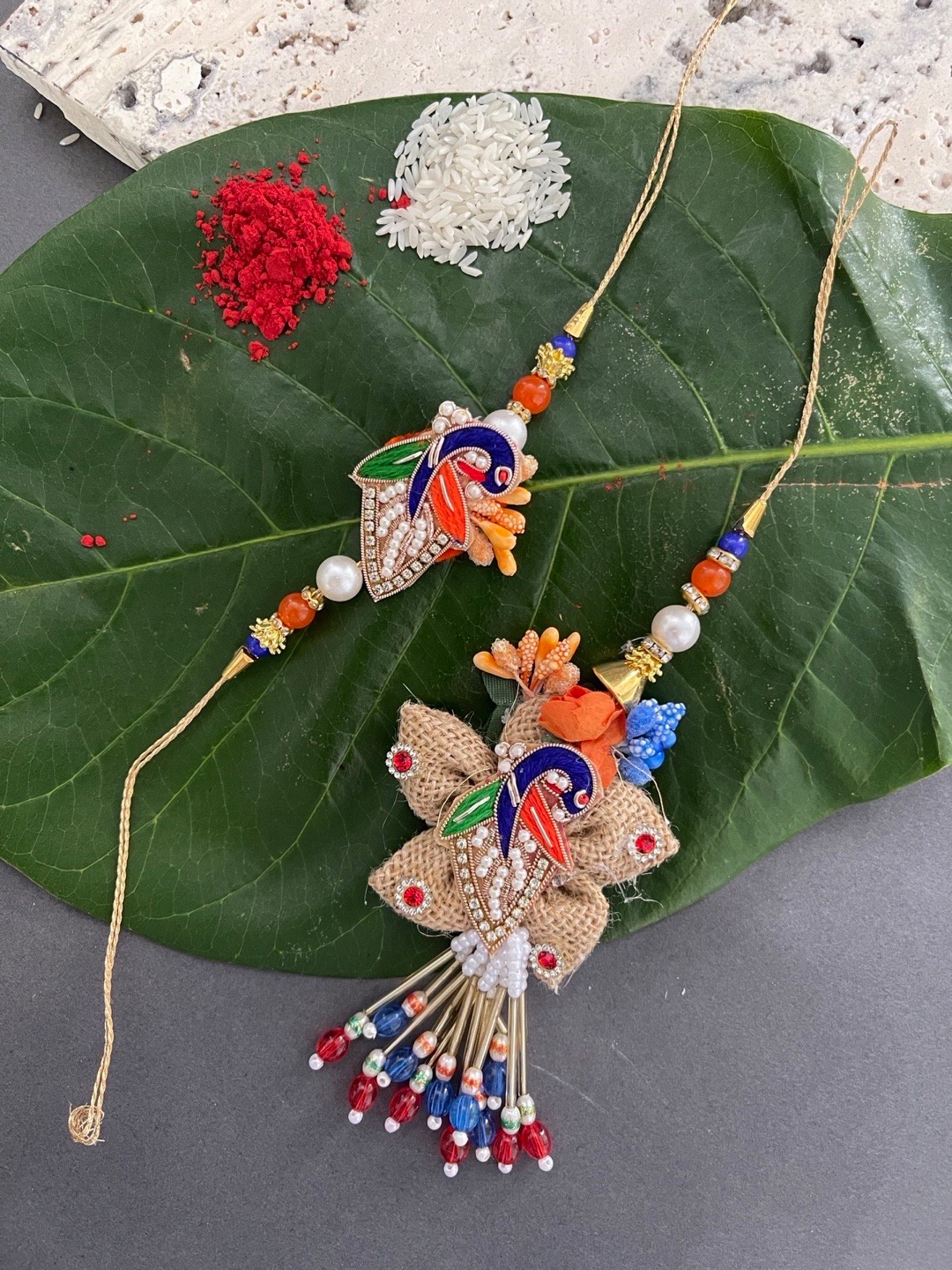 

Digital Dress Room Set Of 2 Orange & Red Beaded Rakhi & Lumba