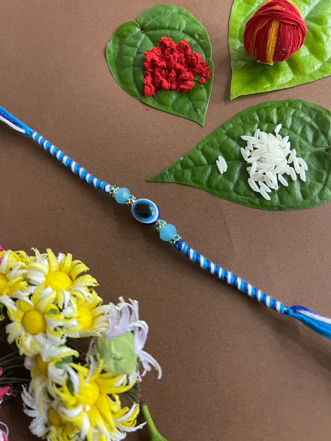 

Digital Dress Room Men Blue & White Crystal Beaded & Evil Eye-Charm Rakhi With Roli