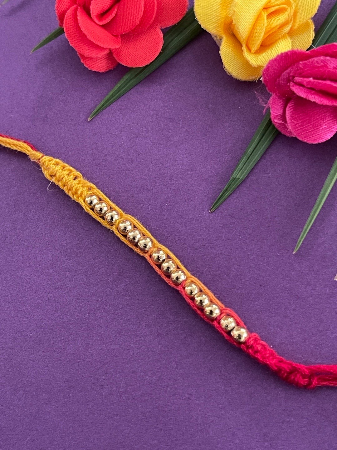 

Digital Dress Room Men Red & Yellow Gold Toned Beaded Rakhi