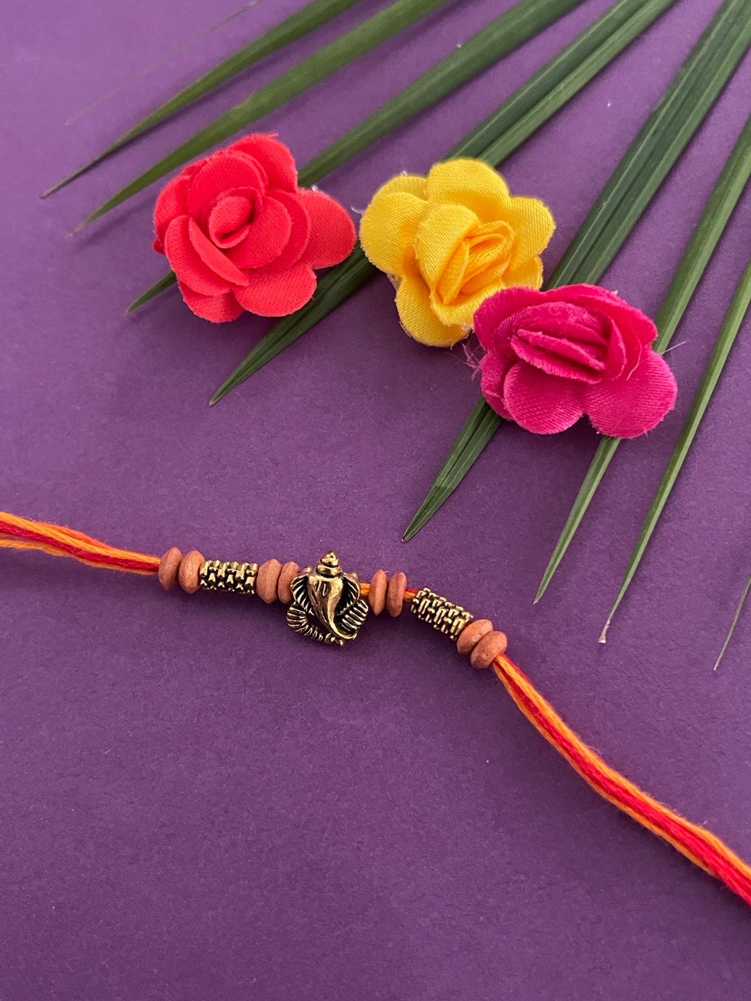 

Digital Dress Room Men Gold-Toned & Red Beaded & Lord Ganesh-Charm Rakhi With Roli