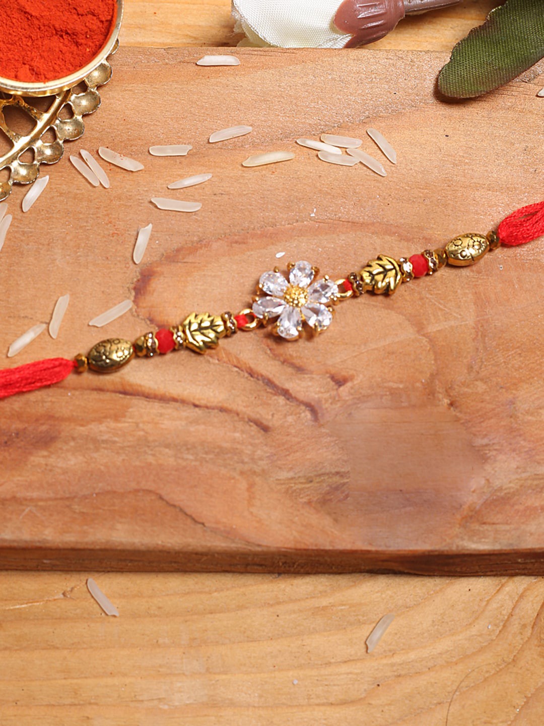 

Aapno Rajasthan Gold-Toned & White Flower Rakhi