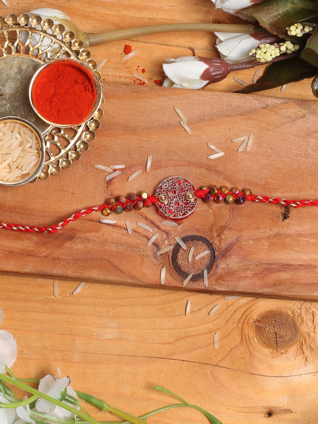 

Aapno Rajasthan Red & Silver-Toned Designer Rakhi with Roli Chawal & Greetings Card