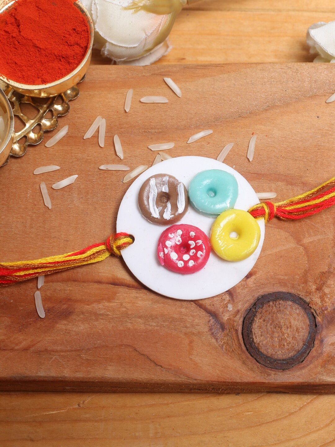 

Aapno Rajasthan Multicoloured Colourful Doughnut Rakhi Roli Chawal & Card, Multi