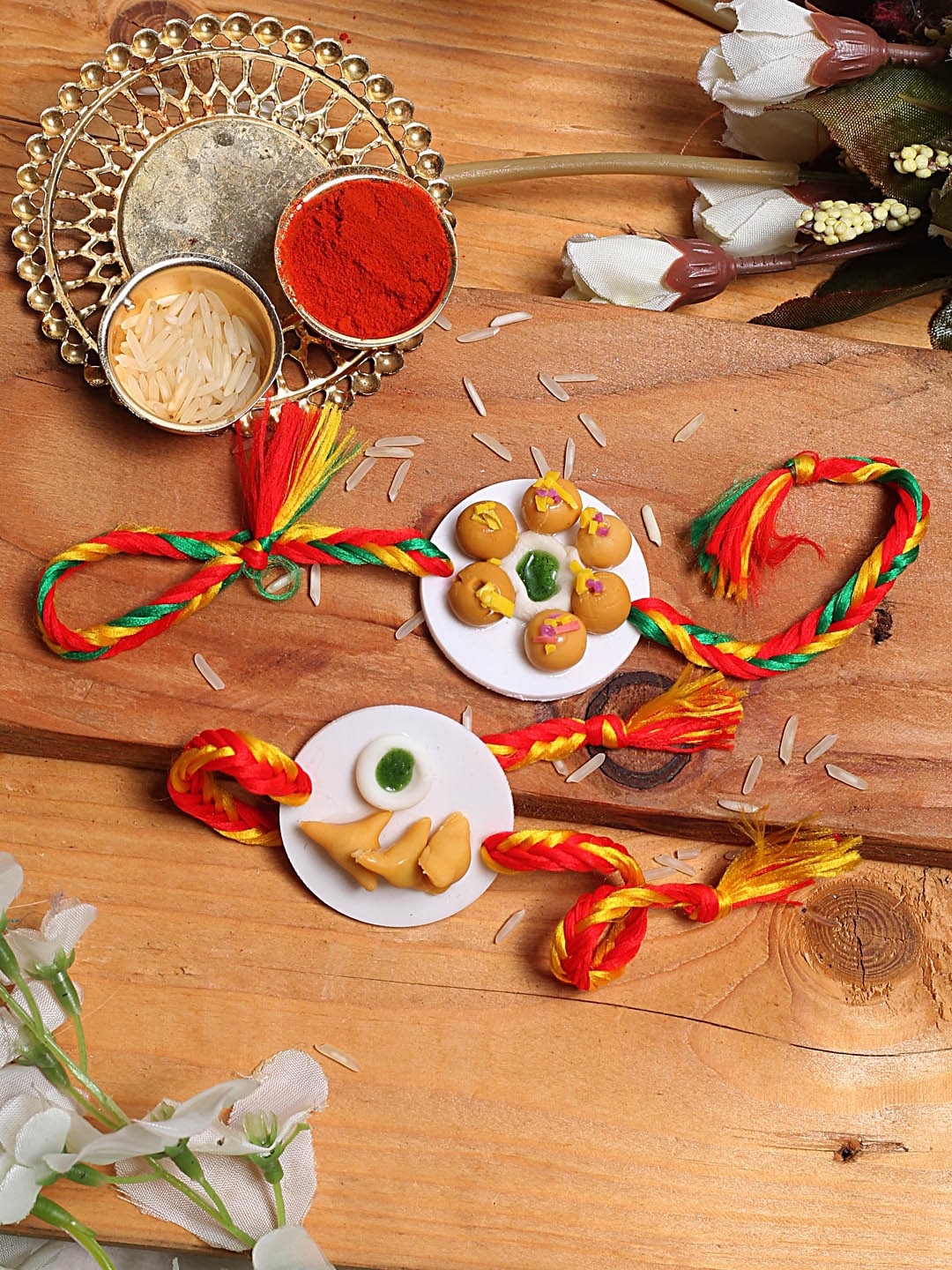 

Aapno Rajasthan Kids Set Of 2 Orange & Red Samosa & Laddu Rakhis